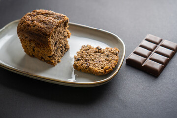 food photography: a small piece of cake on a stylish plate with a piece of chocolate