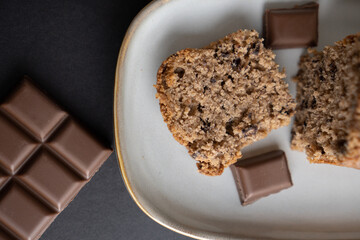 food photography: a small piece of cake on a stylish plate with a piece of chocolate