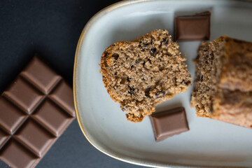 food photography: a small piece of cake on a stylish plate with a piece of chocolate