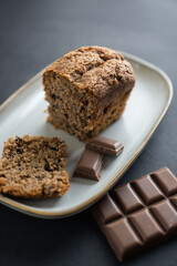 food photography: a small piece of cake on a stylish plate with a piece of chocolate