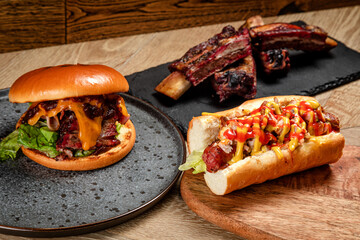 fast food burger hondog and ribs on wooden background