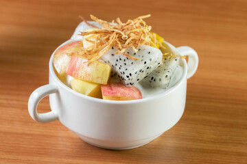 Mixed fruit yogurt in a white cup