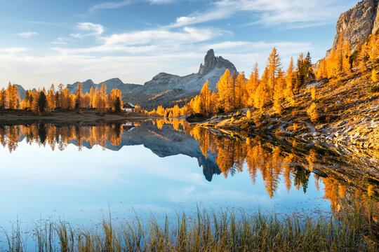 Picturesque view on Federa Lake in sunrise time. Autumn mountains landscape with Lago di Federa and bright orange larches in the Dolomite Apls, Cortina D'Ampezzo, South Tyrol, Dolomites, Italy