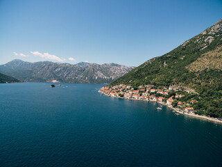 Fototapeta na wymiar Drone view of the Perast coast at the foot of the green mountain. Montenegro