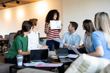 Businesswoman showing a document to her colleagues