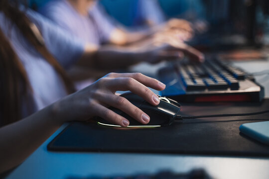 Female cyber sport gamer holding hand at the computer mouth while training