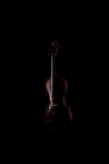 A wooden violin or viola on a black background