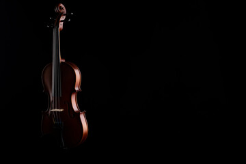 A wooden violin or viola on a black background