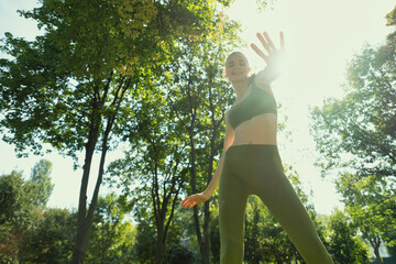 Young woman doing yoga exercise outdoor in the park, sport yoga 