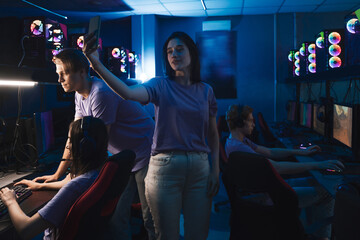 Woman making selfie at the smartphone during the cyber sport tournament