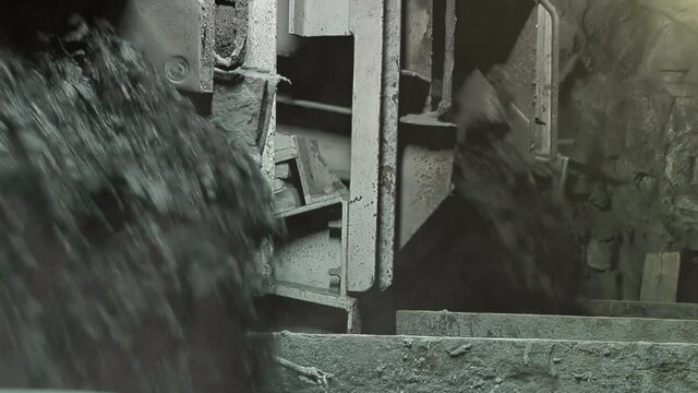 Heavy Machinery Dropping Coal and Rock Inside Underground Mine, Close Up