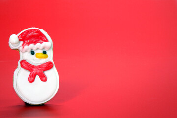Christmas cookies on red background, Christmas greeting card with cute snowman cookies on red background, copy space. Xmas 