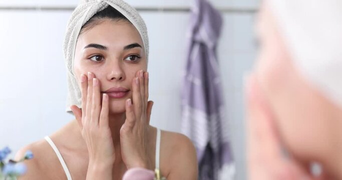 young woman applying face skin care