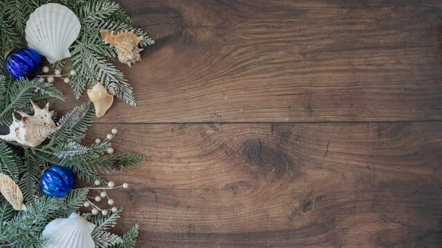 Stop motion Animation of Christmas Decorations with Shells on a Wooden Background