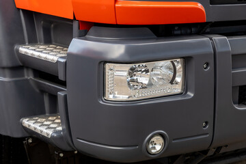 A headlight of a new truck. Detail of a lorry. Truck electrical equipment close-up. Lighting and road safety © hodim