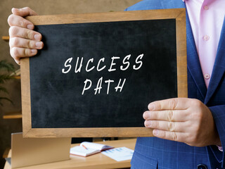 Business concept about SUCCESS PATH with sign on the blackboard.