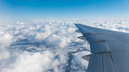 Fototapeta na wymiar flight over winter landscape with clouds
