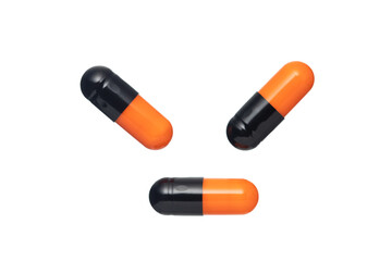 Black-Orange capsule pills,  Isolated on a white background.