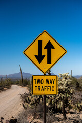 Two Way Traffic Sign Along Desert Dirt Road