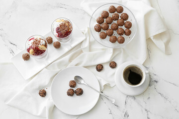 Tasty desserts with flax seeds and cup of coffee on white background