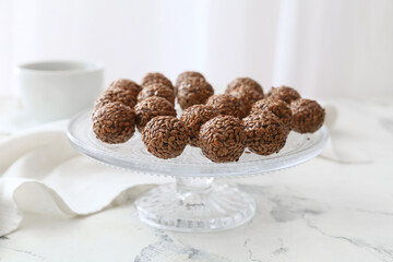 Dessert stand with tasty flax seed candies on white background