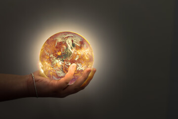 child hand hold world on fire in world planet earth environment conservation and protection from global warming(Elements of this Image Furnished by NASA)