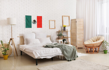 Interior of stylish bedroom with Mexican flag