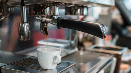 Cup of fresh coffee on a coffee maker