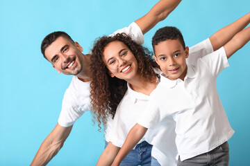 Happy interracial family on color background