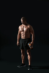 Fototapeta na wymiar Male bodybuilder with protein shake on dark background