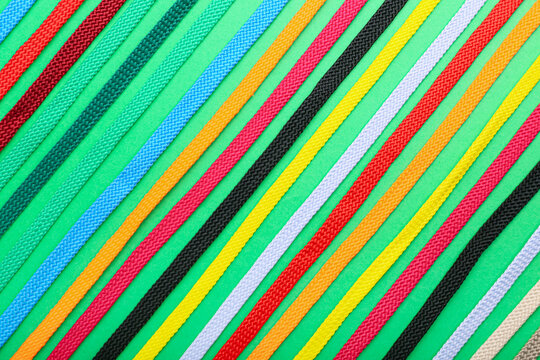 Many shoe laces on color background, closeup