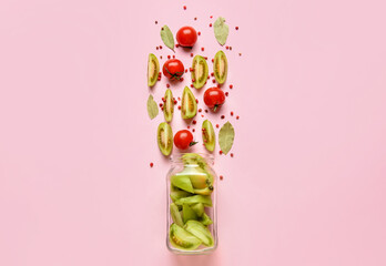 Glass jar with ingredients for preparing canned tomatoes on color background