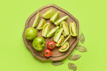 Board with ingredients for preparing canned tomatoes on color background