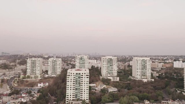 Drone wide angle shot over La Enramada cityscape in Mexico City on overcast day