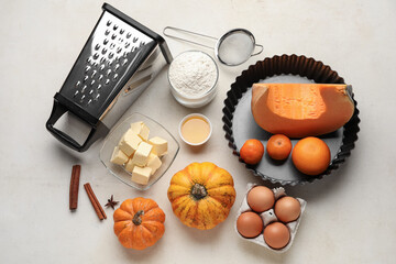Fototapeta na wymiar Fresh ingredients for pumpkin pie on white background
