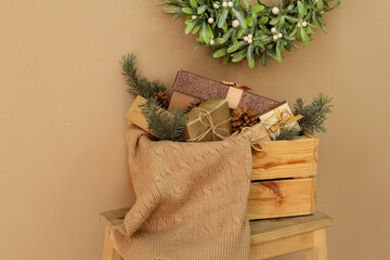 Box with Christmas gifts on color background