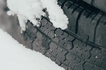 Old car tires under the snow. Used tires. Environmental pollution. Selective focus, copy space