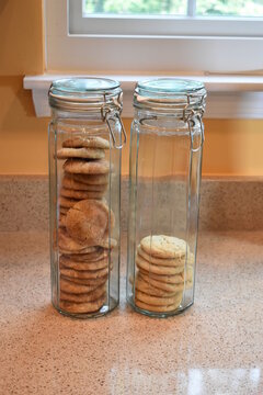 Cookies, Stacked Side By Side, In Two, Tall, Thin, Glass Cookie Jars