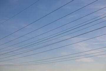 Renewable energy, high voltage lines, high voltage lines at the blue sky and a few white clouds
