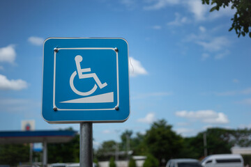 A disabled person with wheel chair icon on blue square metal plate. Traffic information sign and...
