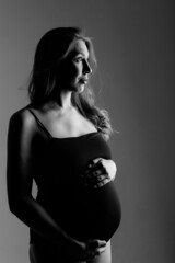 Naklejka premium caucasian pregnant woman stroking her belly on white background. Copy space. The concept of healthy digestion, lifestyle, IVF