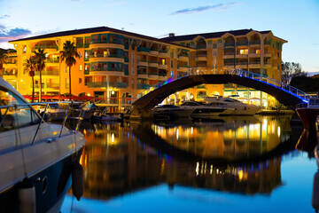 Picturesque evening view of coastal area of Frejus with comfortable residential buildings along...
