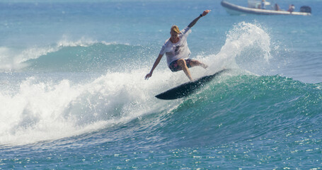 Surfer surfing ocean wave attacking off the lip