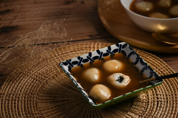Glutinous rice balls with black sesame in sweet ginger soup, Asian Dessert appetizer.