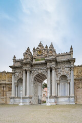 Fototapeta premium Dolmabache palace main entrance gate in Istanbul, Turkey. Dolmabache served as the main administrative center of the Ottoman Empire and is popular for tourists and visitors.