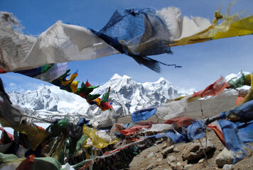 Prayer flags flutter on the backdrop of Mt. Khangchenghao (male) and Mt. Chomoyomo (female) look...