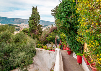 Stone steps, narrow alley in Anafiotika, a scenic tiny neighborhood of Athens, Greece. Anafiotika is part of the old historical neighborhood of Plaka, in northerneast side of the Acropolis hill.
