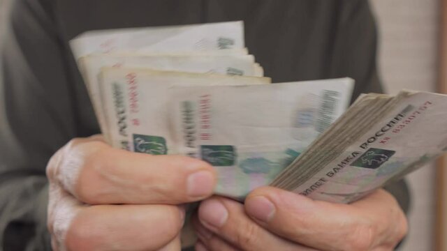 Close-up, a man is counting banknotes in rubles. Unrecognizable person. 