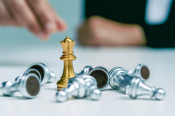 business woman in a suit plays chess. Close-up of a female hand on a pawn chess board game...