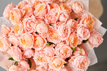 rose juliet. Floral carpet, flower texture, shop concept. Beautiful fresh blossoming flowers roses, spray roses. Blossom in vases and pails. Top view.